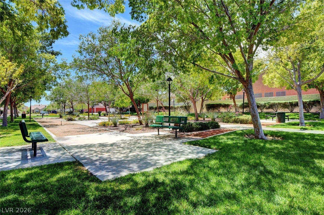 8908 Sheep Ranch Court, Las Vegas, NV 89143 Mature trees shade paved walking paths winding through a peaceful community park.