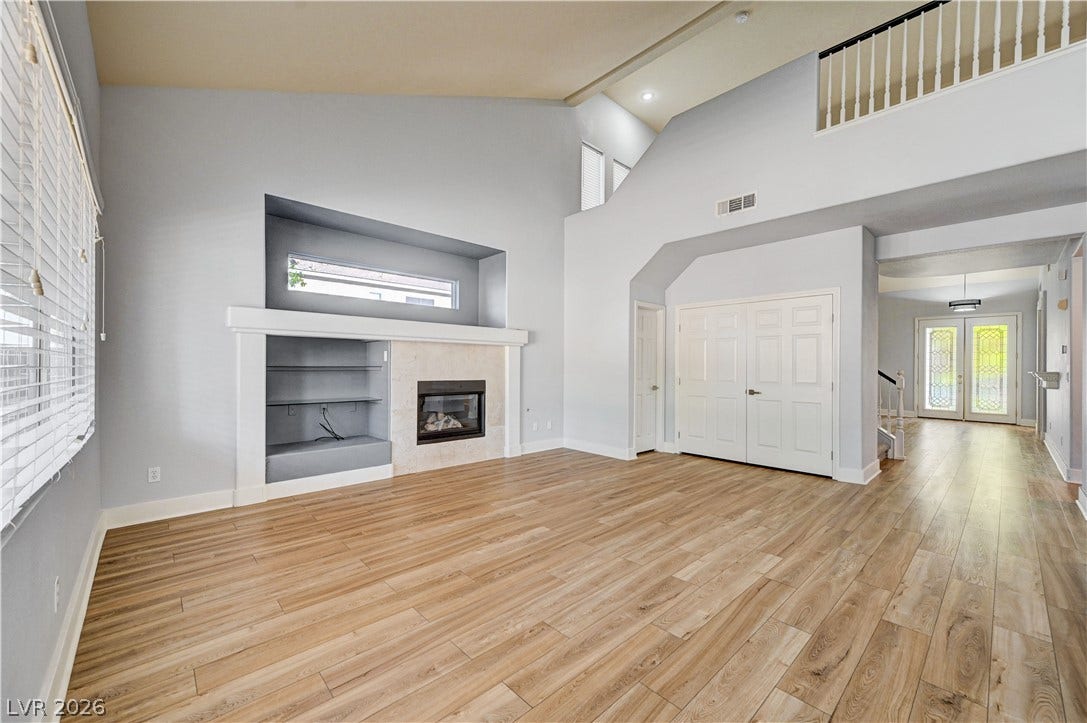 8908 Sheep Ranch Court, Las Vegas, NV 89143 Gleaming wood floors anchor a dramatic great room with soaring vaulted ceilings.