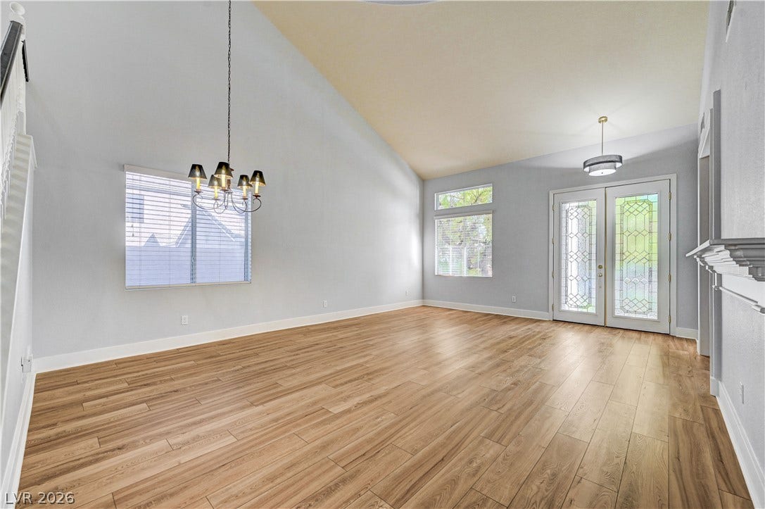 8908 Sheep Ranch Court, Las Vegas, NV 89143 High vaulted ceilings and wood-inspired flooring elevate this versatile open living space.