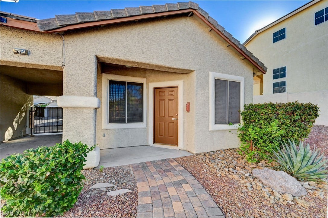 8908 Sheep Ranch Court, Las Vegas, NV 89143 An inviting paved walkway leads directly to the covered entry of this low-maintenance stucco home.