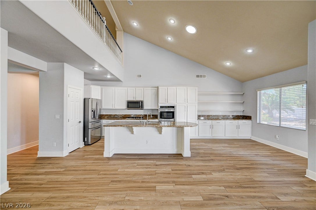 8908 Sheep Ranch Court, Las Vegas, NV 89143 Vaulted ceilings soar over a modern open-concept kitchen and spacious wood-look flooring.