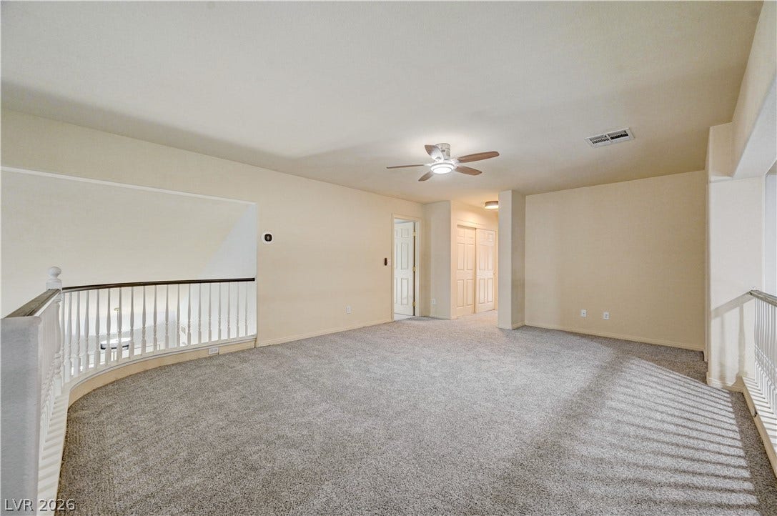 8908 Sheep Ranch Court, Las Vegas, NV 89143 An open upstairs loft features neutral walls and plush wall-to-wall carpeting.