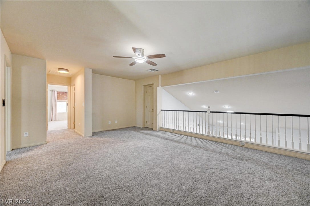 8908 Sheep Ranch Court, Las Vegas, NV 89143 An open upstairs loft overlooks the lower level through a classic railed banister.
