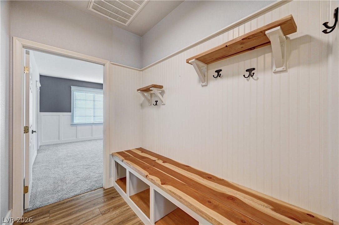 8908 Sheep Ranch Court, Las Vegas, NV 89143 Functional built-in storage bench and custom wall shelving maximize space in this transition zone.