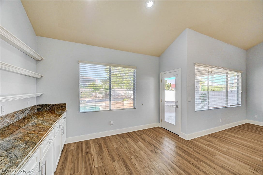 8908 Sheep Ranch Court, Las Vegas, NV 89143 High vaulted ceilings and wood-look flooring enhance this versatile dining area near the kitchen.