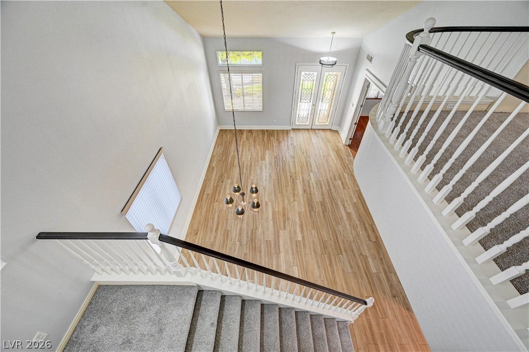 8908 Sheep Ranch Court, Las Vegas, NV 89143 A striking overhead view highlights wood floors, soaring ceilings, and a wrap-around staircase.