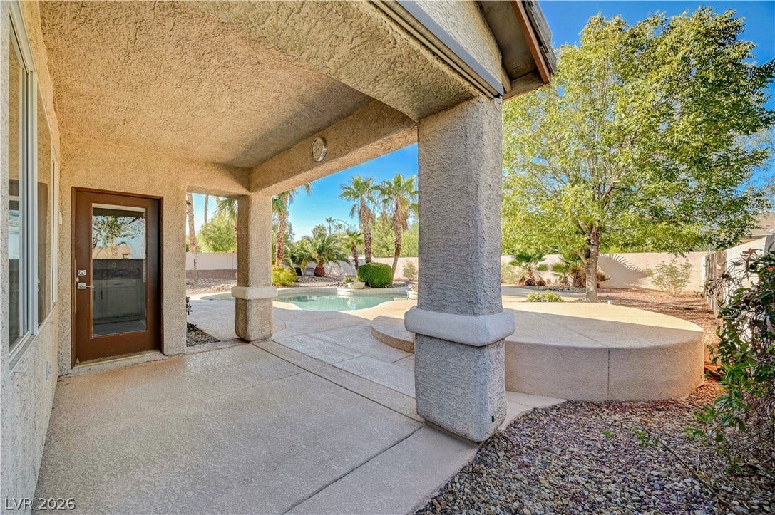8908 Sheep Ranch Court, Las Vegas, NV 89143 Shaded concrete columns frame views of the sun-drenched private pool and surrounding desert landscape.