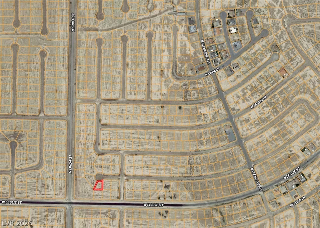 An aerial plat map outlines the boundaries of this residential lot nestled within a developing neighborhood.