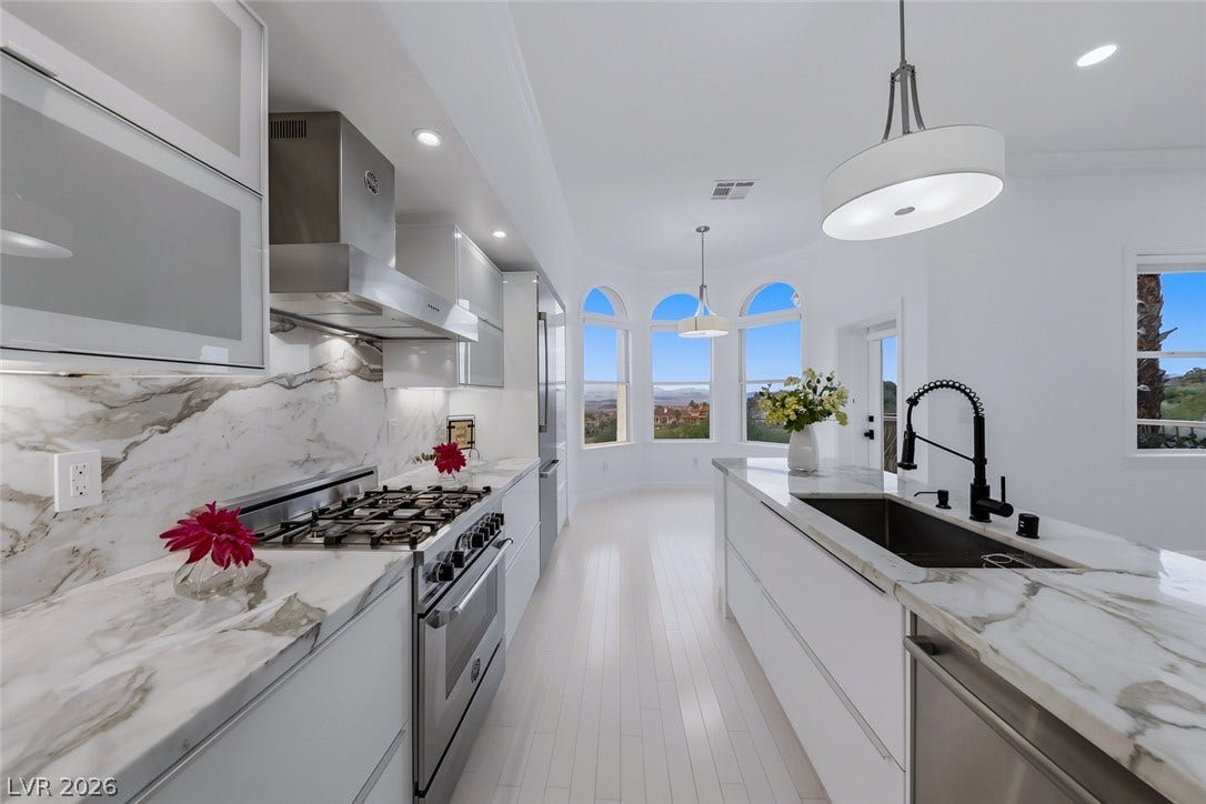 26 Strada Di Circolo, #n/a, Henderson, NV 89011 Marble counters and an expansive island anchor this modern kitchen with scenic window views.