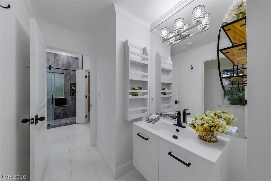 26 Strada Di Circolo, #n/a, Henderson, NV 89011 Polished tile flooring and custom built-in shelving elevate this refined bathroom design.