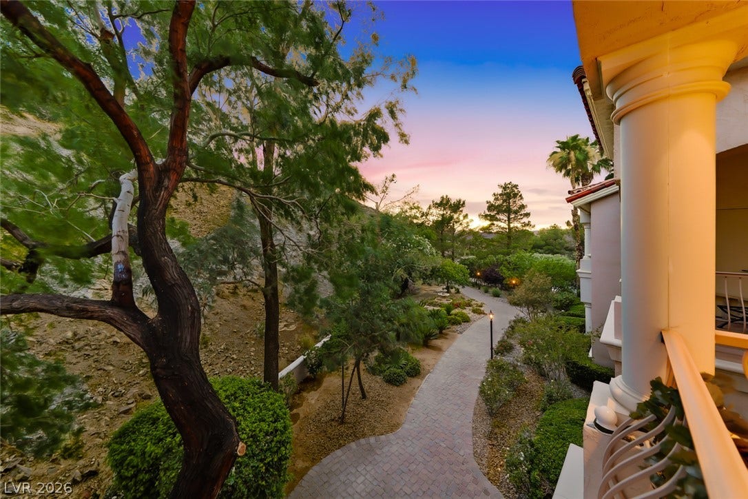 26 Strada Di Circolo, #n/a, Henderson, NV 89011 Mature trees frame a winding stone pathway leading through beautifully landscaped common grounds.