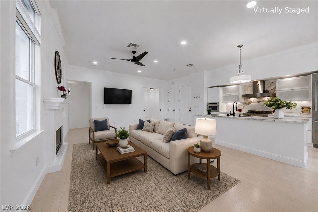 26 Strada Di Circolo, #n/a, Henderson, NV 89011 Sunlight streams through tall windows into an airy living area complete with a fireplace.