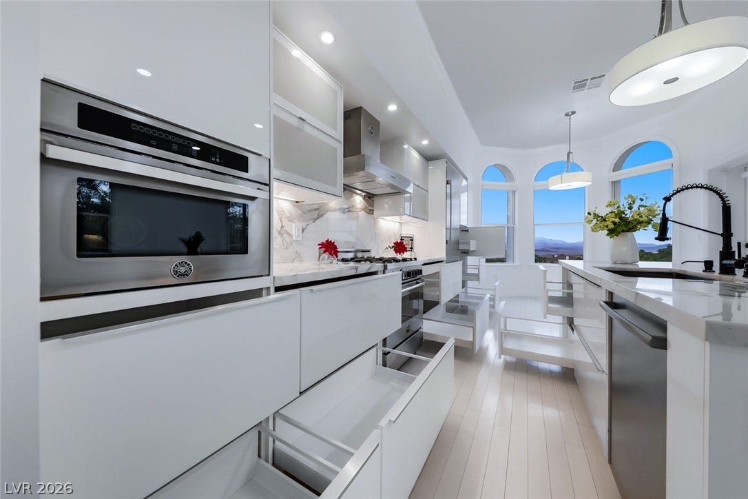26 Strada Di Circolo, #n/a, Henderson, NV 89011 Sleek contemporary cabinetry and stone countertops anchor this modern culinary workspace with scenic views.