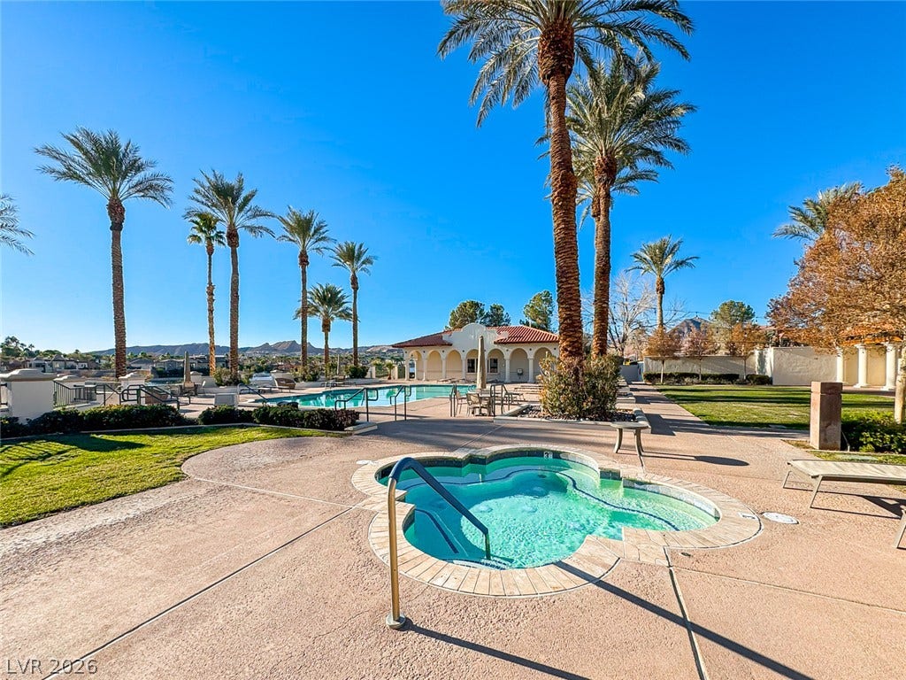 26 Strada Di Circolo, #n/a, Henderson, NV 89011 Towering palm trees frame an inviting in-ground spa alongside a sparkling community pool.
