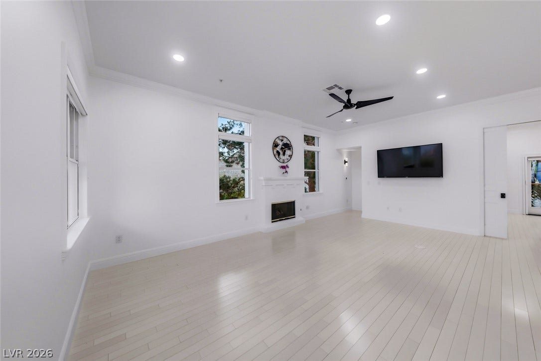26 Strada Di Circolo, #n/a, Henderson, NV 89011 Gleaming hardwood floors and a classic fireplace define this airy, open-concept living space.