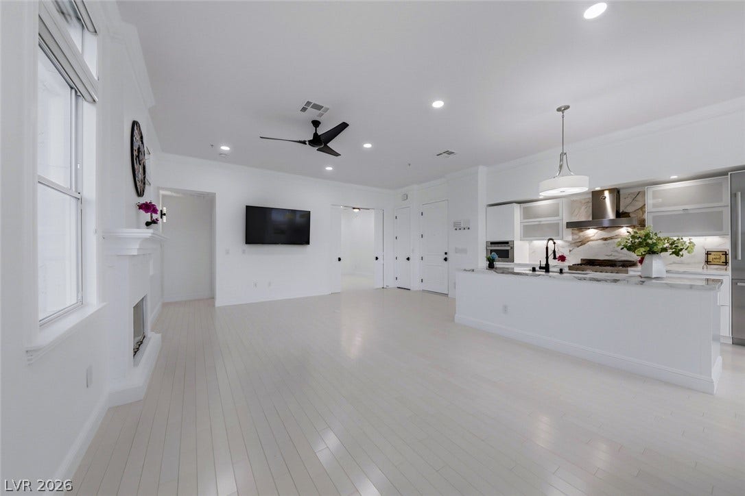 26 Strada Di Circolo, #n/a, Henderson, NV 89011 An open-concept layout seamlessly connects the light hardwood floors, fireplace, and contemporary kitchen.