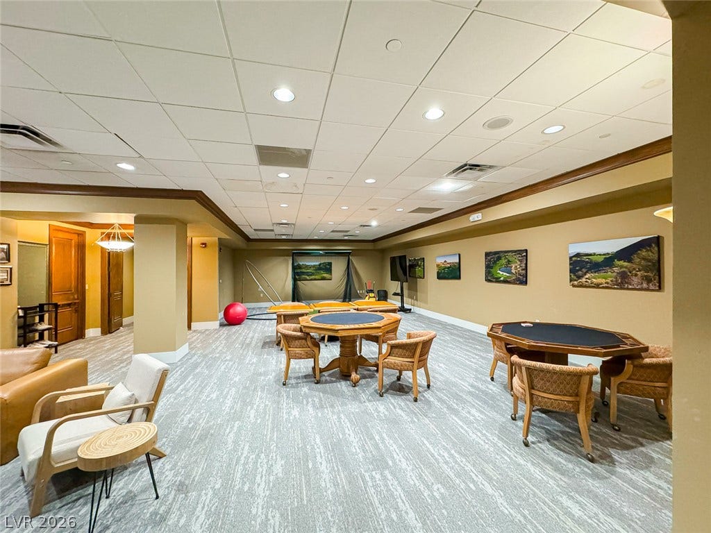 26 Strada Di Circolo, #n/a, Henderson, NV 89011 A spacious recreation room features recessed lighting and clean carpeted floors throughout.