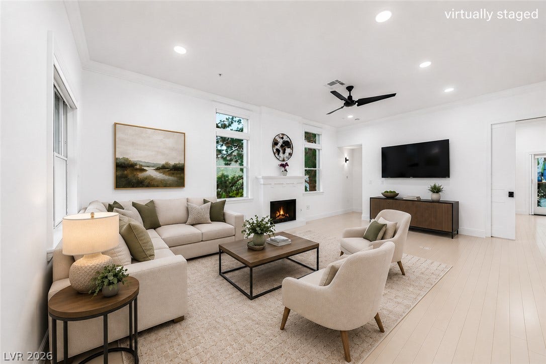 26 Strada Di Circolo, #n/a, Henderson, NV 89011 An inviting fireplace serves as the centerpiece of this light-filled room with elegant wood floors.