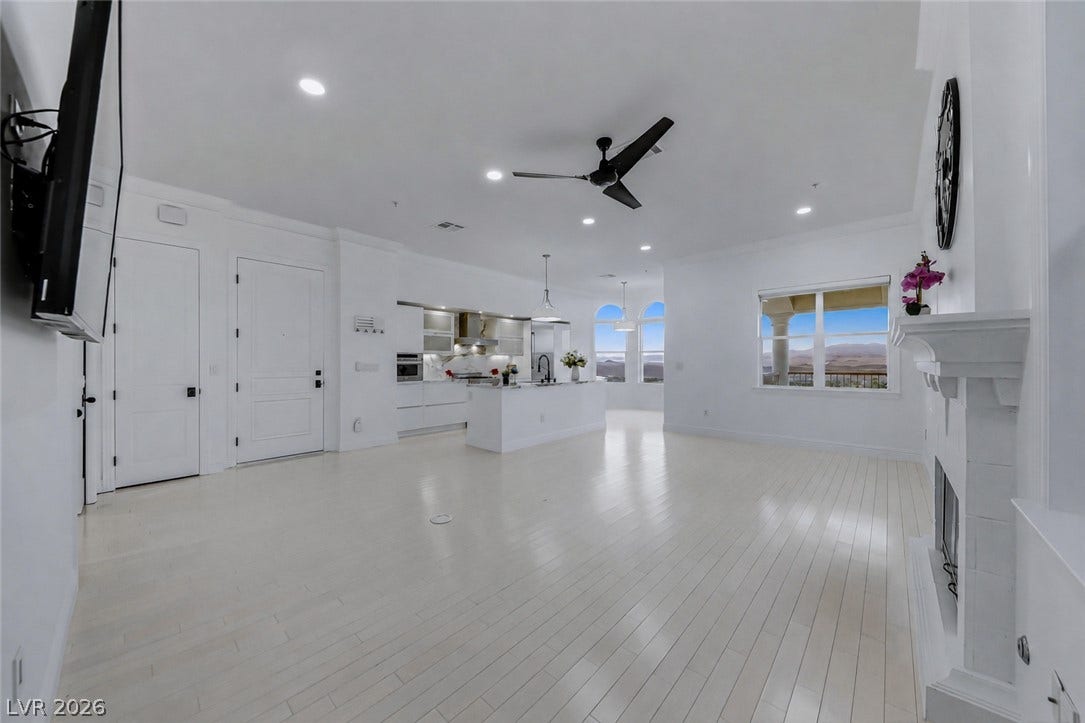 26 Strada Di Circolo, #n/a, Henderson, NV 89011 Gleaming hardwood floors and a white fireplace anchor this airy open concept layout.
