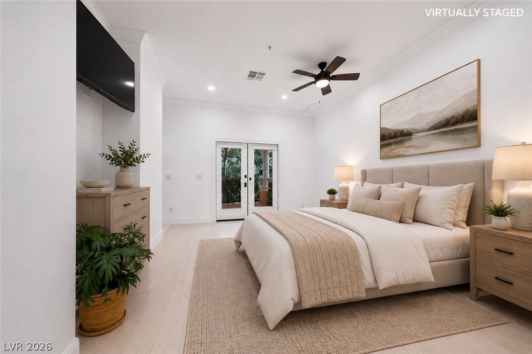 26 Strada Di Circolo, #n/a, Henderson, NV 89011 Double doors open to the outdoors from this bedroom with wood flooring and crown molding.