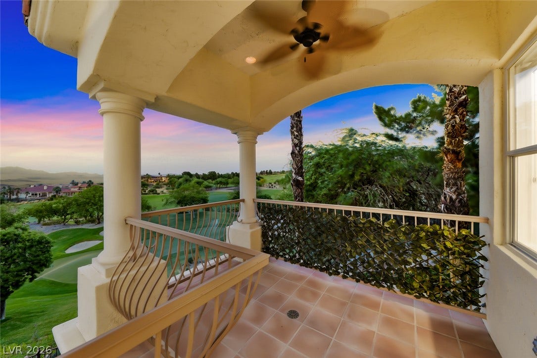 26 Strada Di Circolo, #n/a, Henderson, NV 89011 An elevated tiled balcony overlooks sweeping green fairways under a twilight sky.