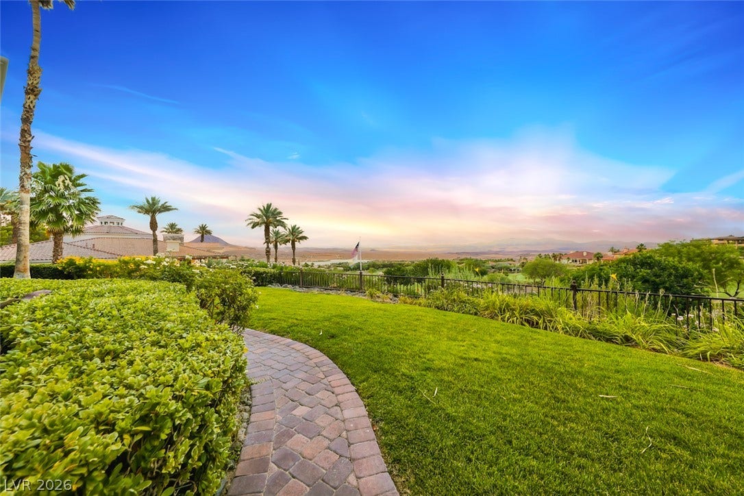 26 Strada Di Circolo, #n/a, Henderson, NV 89011 A curved paver path traverses a manicured lawn overlooking sweeping mountain and desert valley vistas.