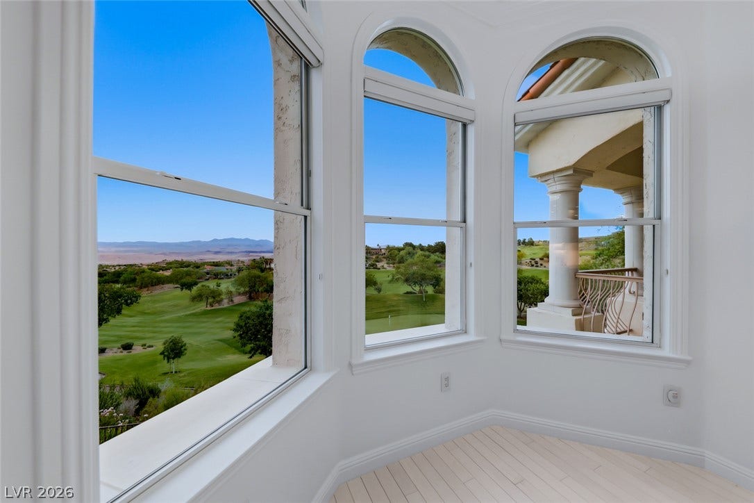 26 Strada Di Circolo, #n/a, Henderson, NV 89011 Large arched windows frame panoramic views of the surrounding golf course green.