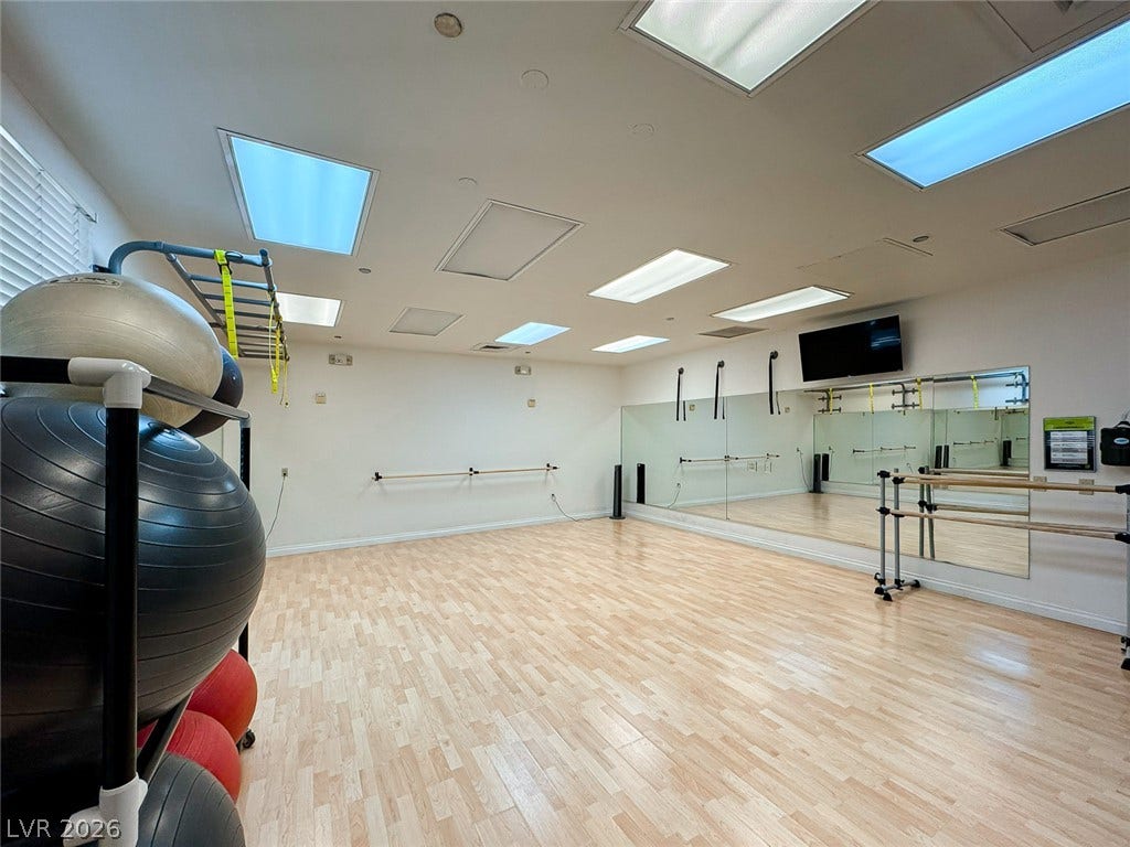 26 Strada Di Circolo, #n/a, Henderson, NV 89011 Smooth wood flooring and a mirrored wall define this spacious home exercise studio.