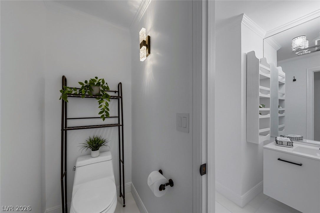 26 Strada Di Circolo, #n/a, Henderson, NV 89011 Crisp molding and minimalist finishes define this modern bathroom with adjacent vanity space.