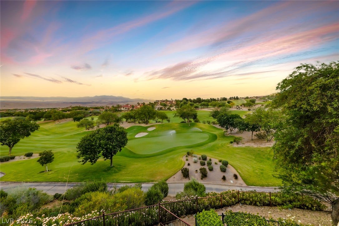 26 Strada Di Circolo, #n/a, Henderson, NV 89011 Lush fairways stretch toward distant mountains under a pastel evening sky.