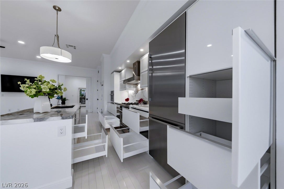 26 Strada Di Circolo, #n/a, Henderson, NV 89011 Sleek contemporary cabinetry with pull-out organizers maximizes storage efficiency in this modern kitchen.