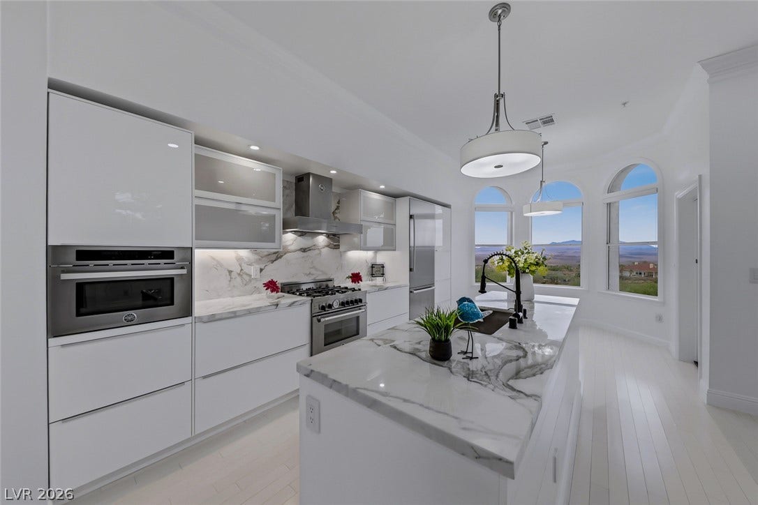 26 Strada Di Circolo, #n/a, Henderson, NV 89011 Arched windows frame far-reaching views in this contemporary culinary space with marble counters.