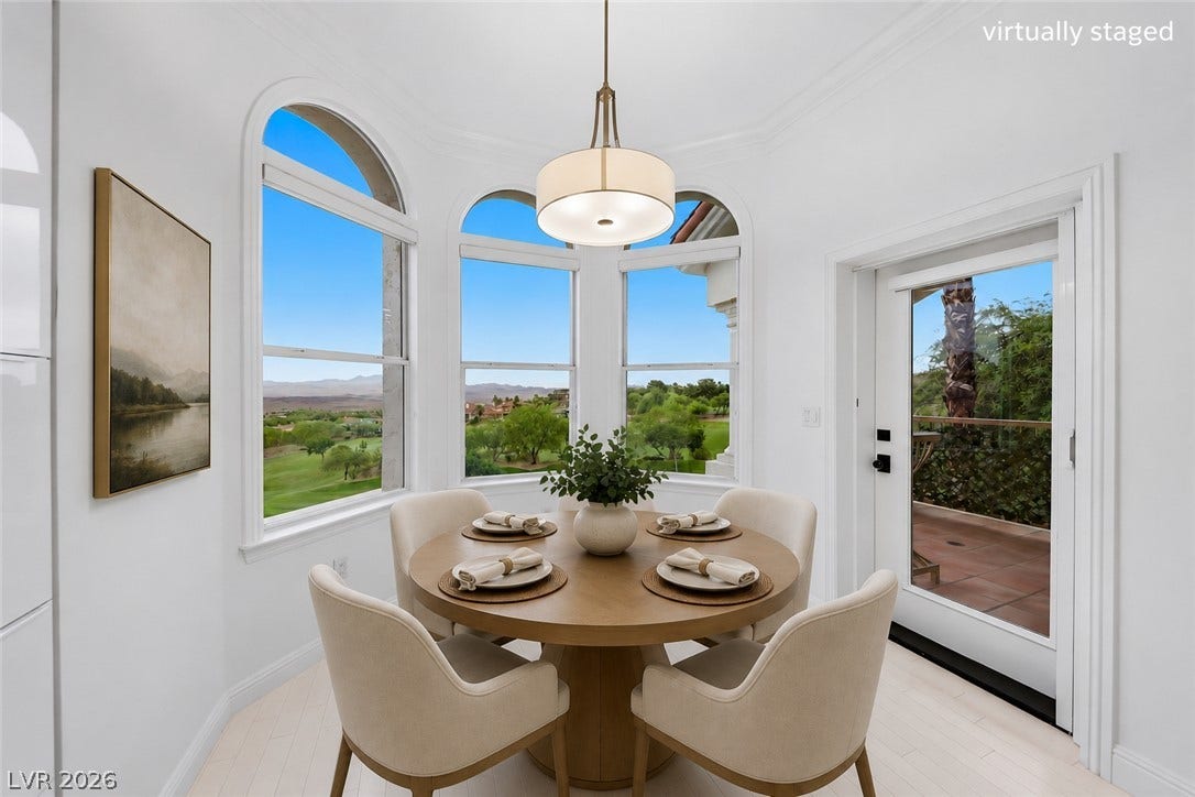 26 Strada Di Circolo, #n/a, Henderson, NV 89011 Elegant arched windows frame scenic golf course views in this sun-lit dining area.