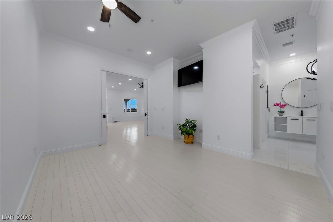 26 Strada Di Circolo, #n/a, Henderson, NV 89011 Crisp white crown molding accents the sleek hardwood floors in this airy modern suite.