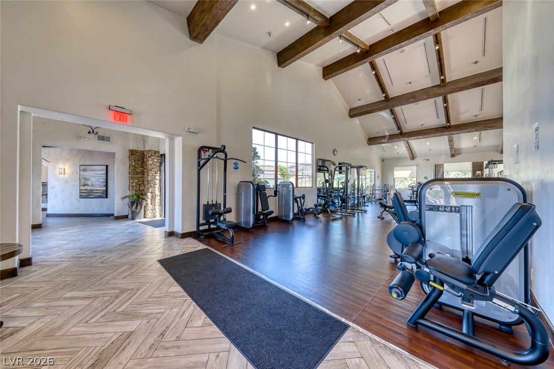 26 Strada Di Circolo, #n/a, Henderson, NV 89011 Soaring beamed ceilings and rich wood-style flooring elevate this modern exercise facility.