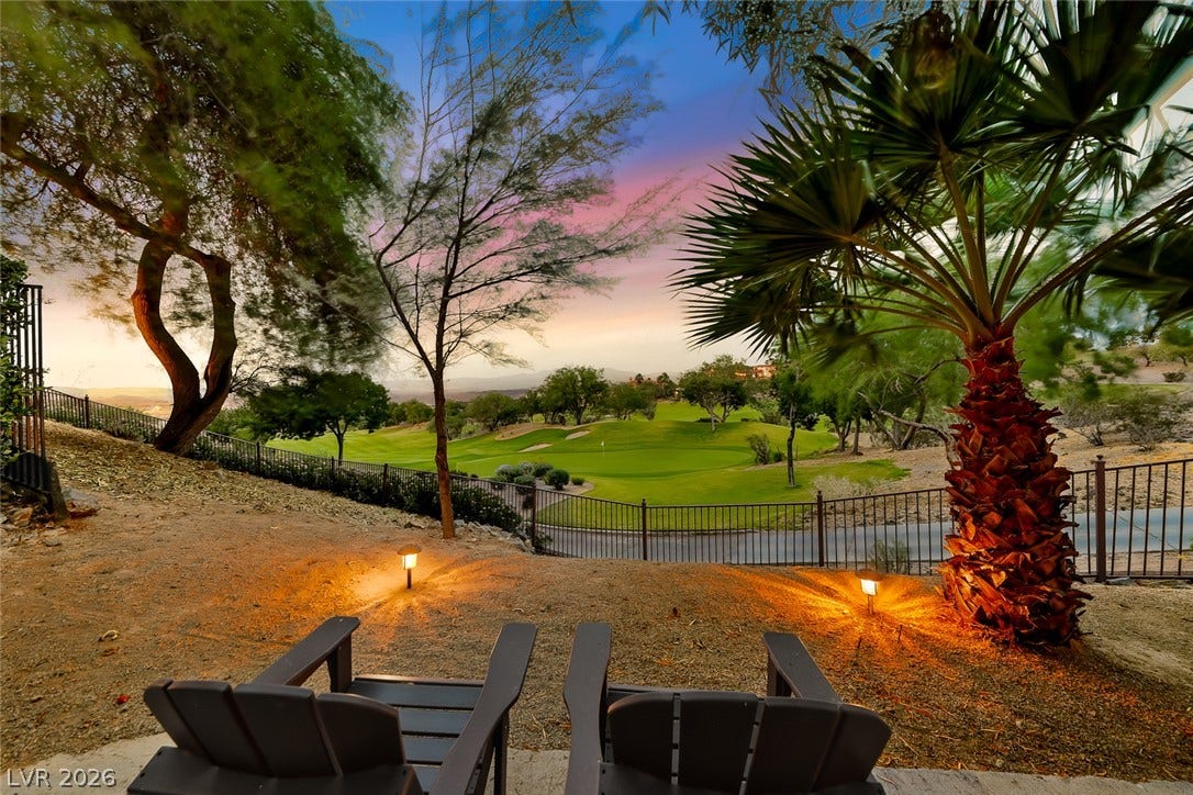 26 Strada Di Circolo, #n/a, Henderson, NV 89011 Lush fairways stretch out beyond the backyard fence under a colorful twilight sky.