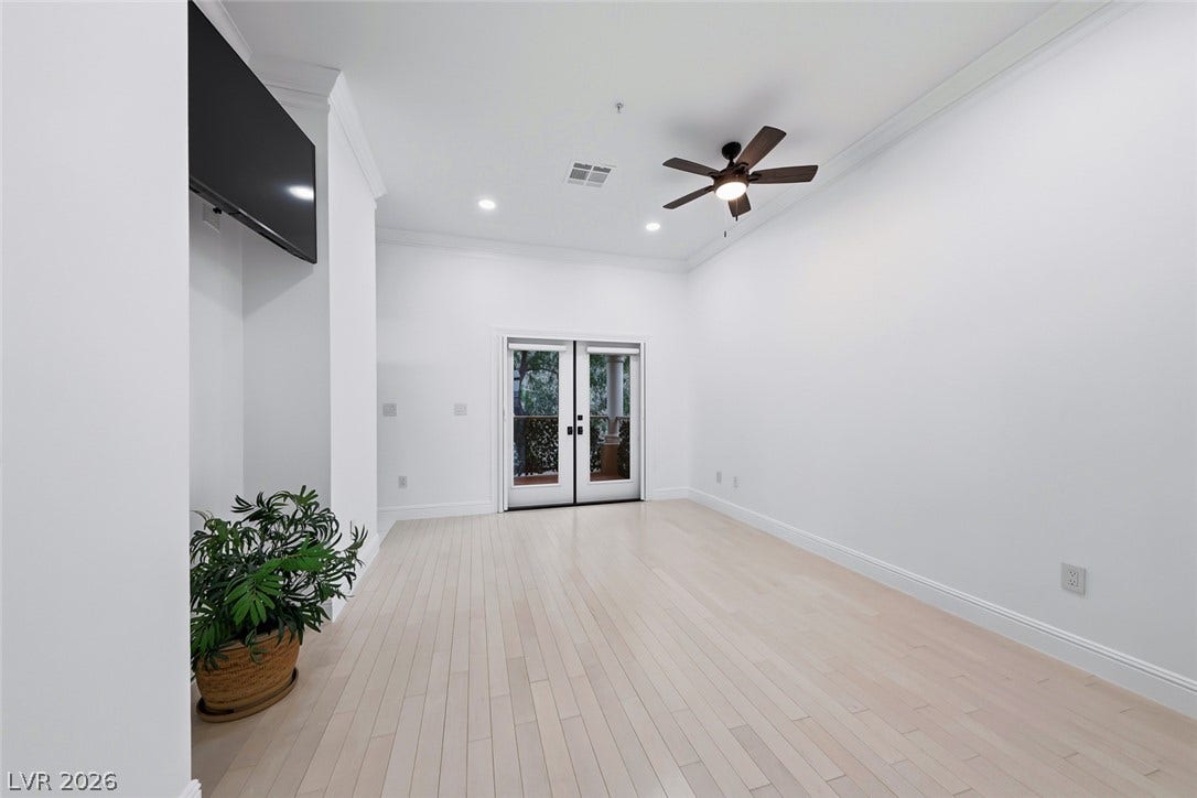 26 Strada Di Circolo, #n/a, Henderson, NV 89011 Double doors open to the outdoors from this airy space featuring clean wood flooring.
