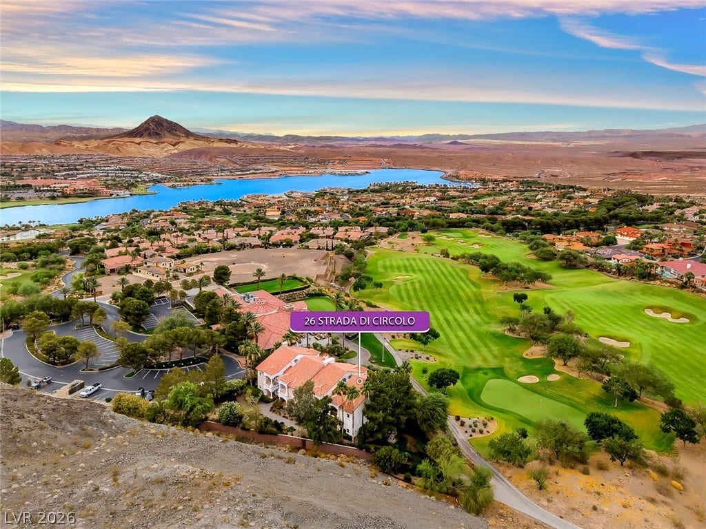 26 Strada Di Circolo, #n/a, Henderson, NV 89011 Lush golf course greens and shimmering lake waters highlight this scenic desert landscape view.