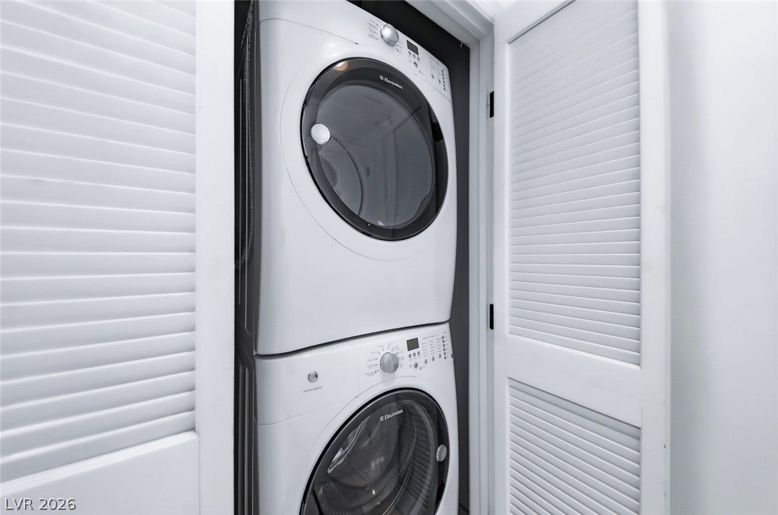 26 Strada Di Circolo, #n/a, Henderson, NV 89011 A stacked laundry setup is neatly tucked behind louvered closet doors.