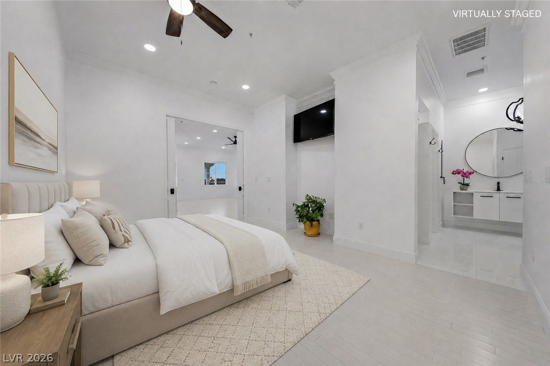 26 Strada Di Circolo, #n/a, Henderson, NV 89011 Smooth wood floors and crisp crown molding frame this modern primary suite with an open-concept bath.