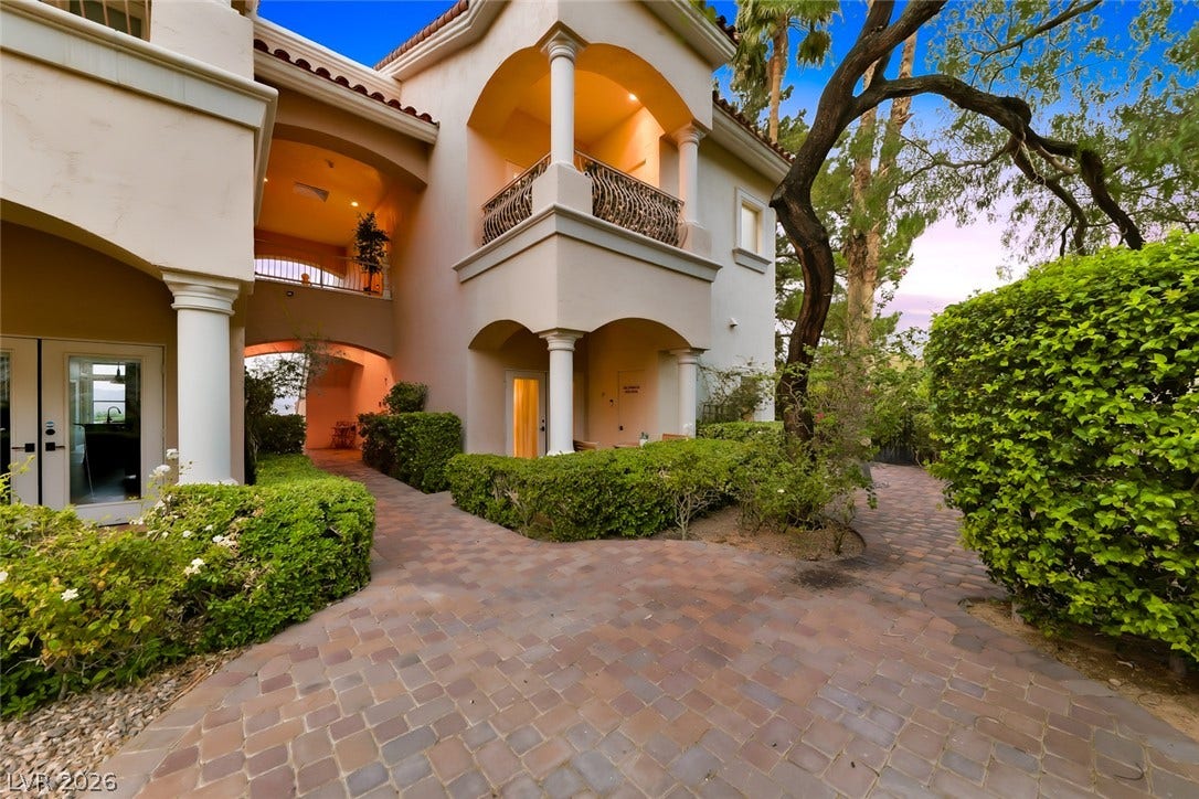 26 Strada Di Circolo, #n/a, Henderson, NV 89011 Elegant Mediterranean architecture frames a beautifully paved stone pathway leading through manicured garden landscaping.
