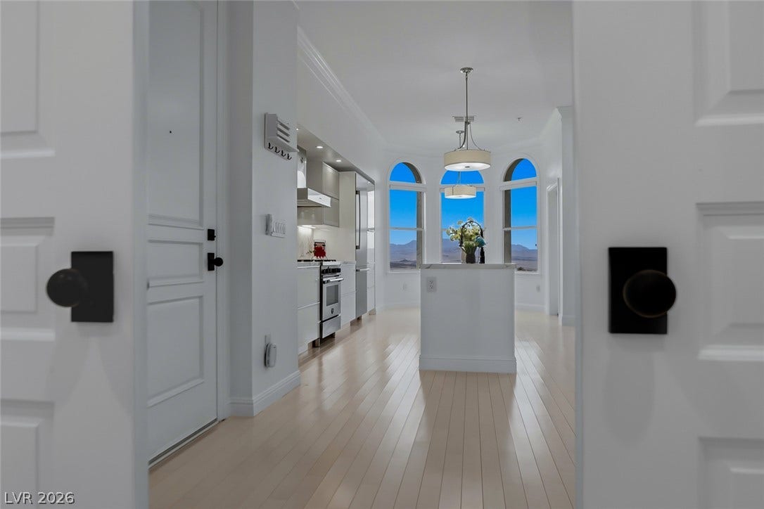 26 Strada Di Circolo, #n/a, Henderson, NV 89011 Arched windows frame far-reaching mountain vistas beyond a bright kitchen and gleaming hardwood floors.