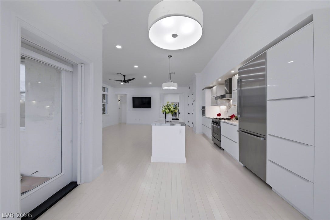 26 Strada Di Circolo, #n/a, Henderson, NV 89011 Crisp minimalist design details define this seamless open-concept kitchen and living area.