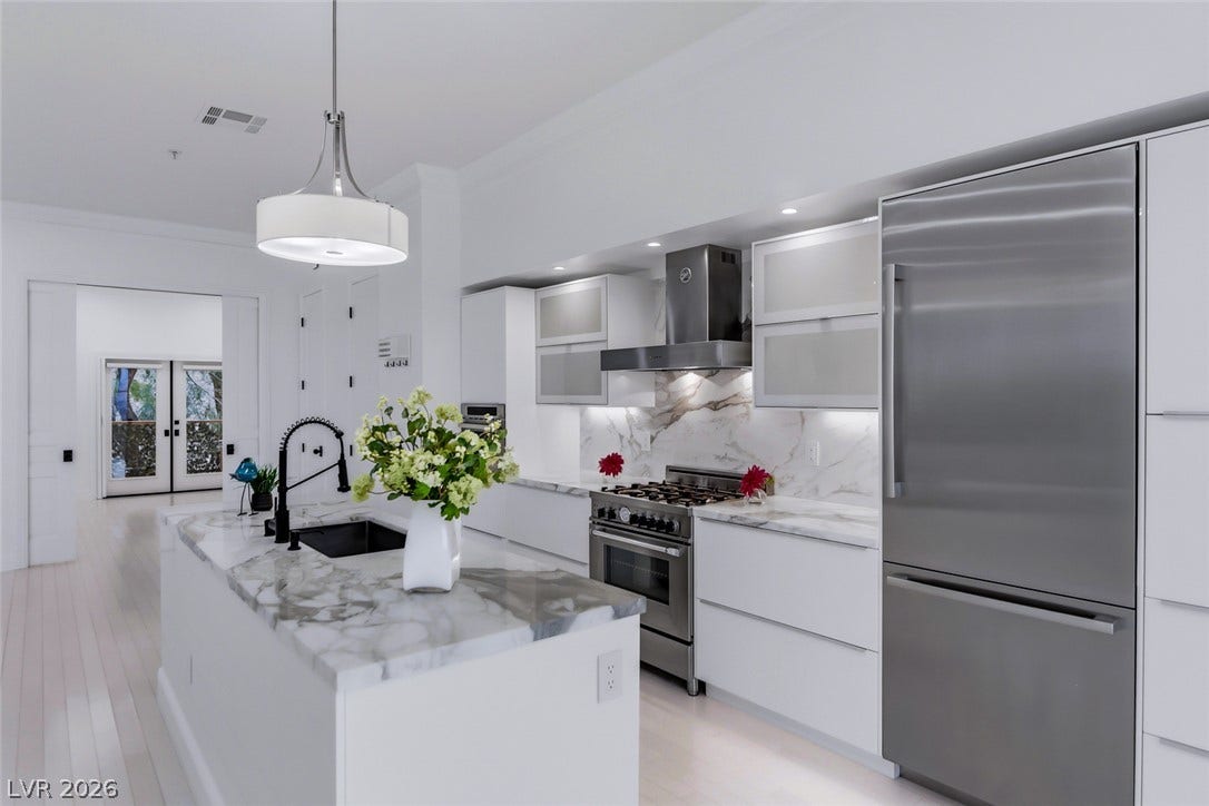 26 Strada Di Circolo, #n/a, Henderson, NV 89011 Premium marble countertops and professional-grade appliances anchor this sleek, modern culinary space.
