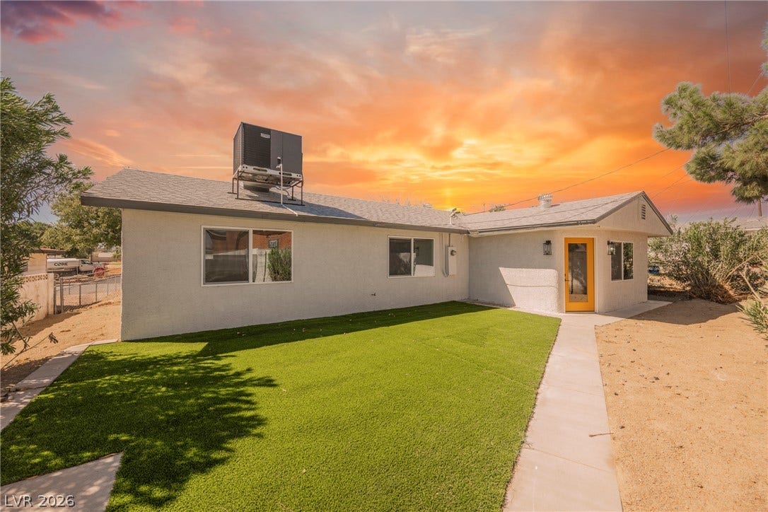 Green lawn and paved walkways define this inviting outdoor space.