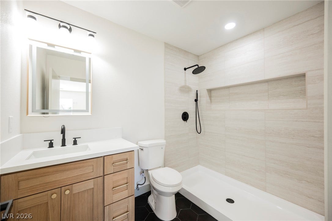 Clean lines and modern tilework define this beautifully appointed full bathroom.