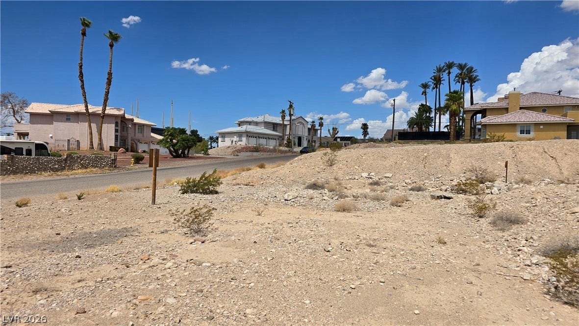 740 Benedict Drive, Las Vegas, NV 89110 An open desert lot rests under blue skies within an established neighborhood of custom homes.