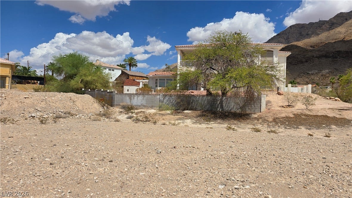 740 Benedict Drive, Las Vegas, NV 89110 An elevated residential lot features mountain backdrops under desert skies.