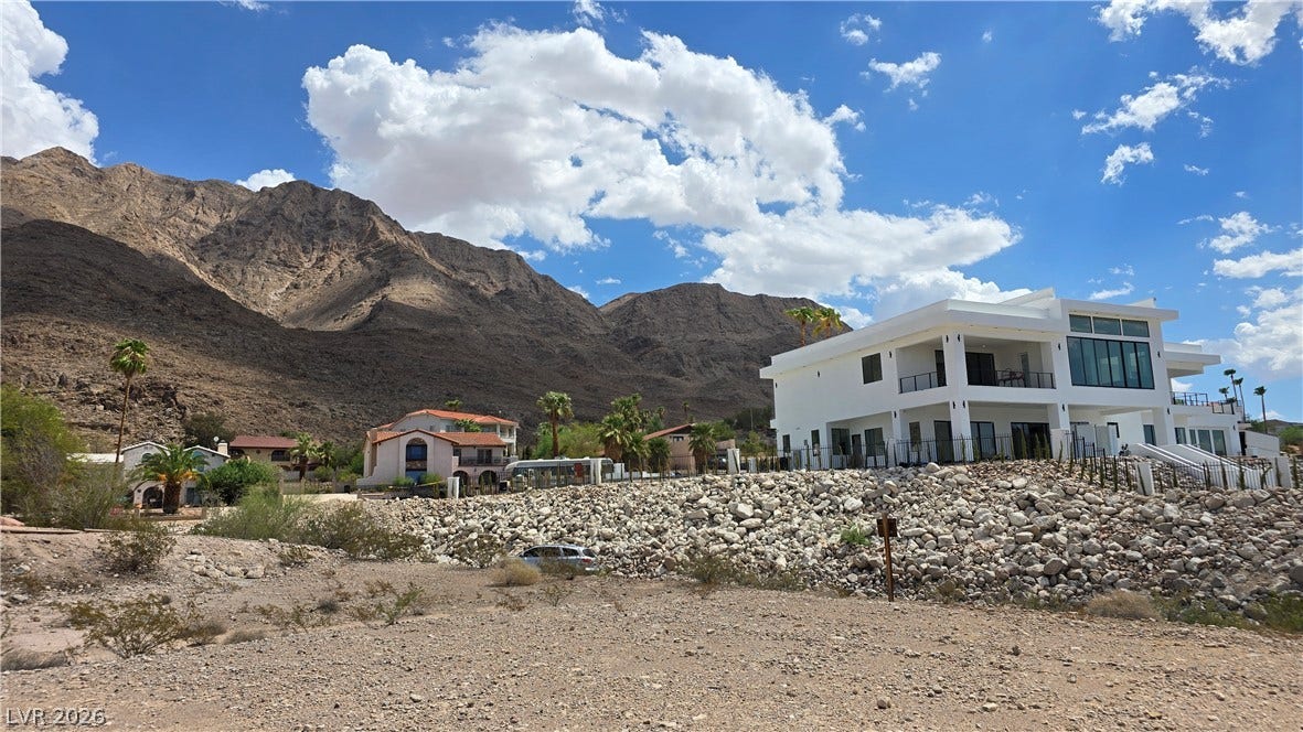 740 Benedict Drive, Las Vegas, NV 89110 Dramatic mountain backdrops frame this modern multi-level residence perched on a rocky elevated terrain.