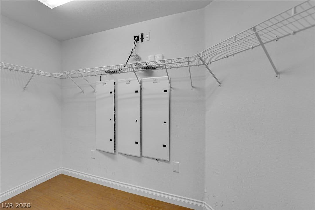 9852 Snowy Canyon Court, Las Vegas, NV 89183 Ample wire shelving wraps around this utility closet featuring warm wood floors.
